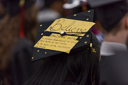 academic cap with the word believe written on it