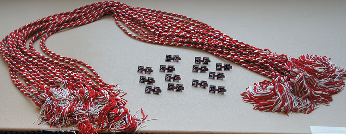 red and white graduation cords laying on table