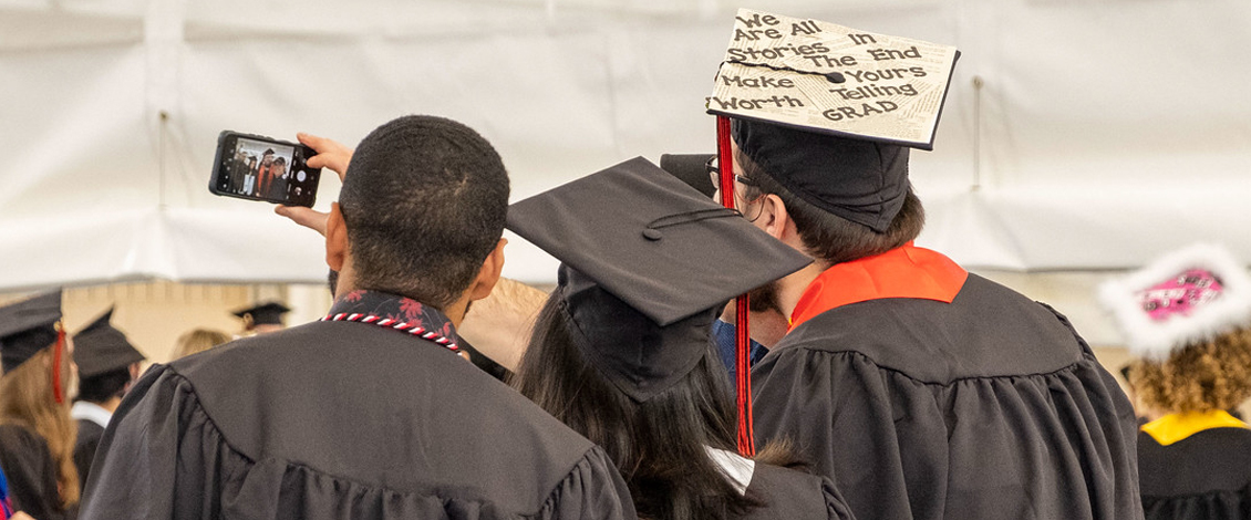 Students wearing decorated caps at commencement